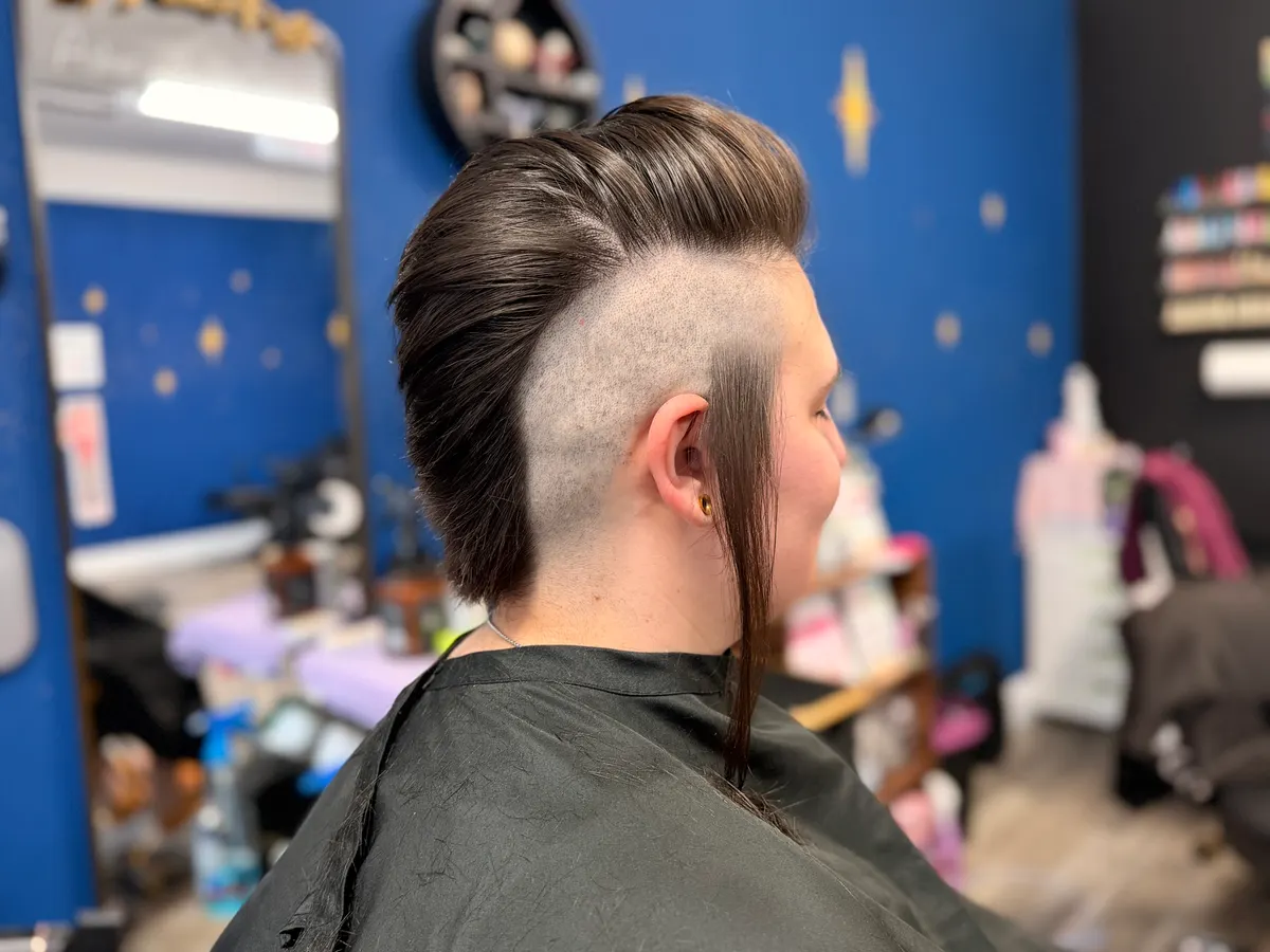 Sharp shaved-side slick-back mullet with a clean undercut, by Asher