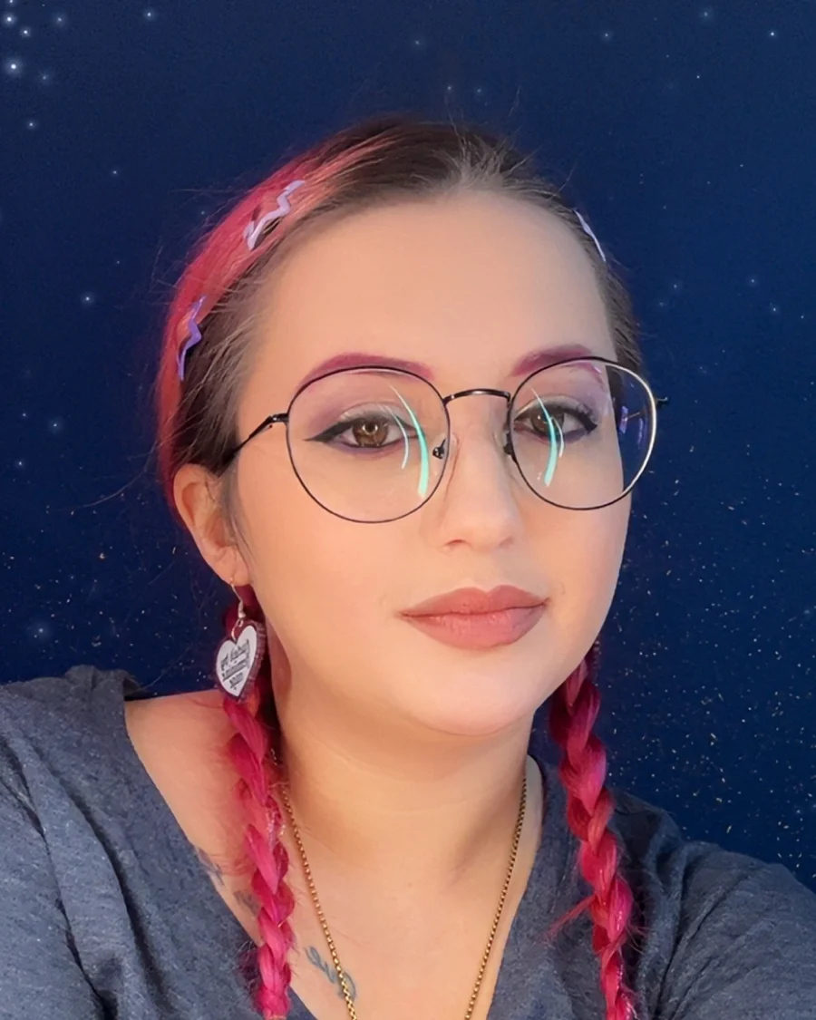 Victoria Bustos, nail technician, with pink braided hair against a starry celestial backdrop